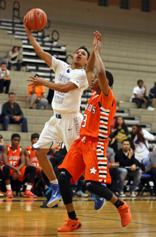 Desert Pines’ Coby Myles, left, goes for a layup past Chaparral’s Marc Silas on Wedn ...