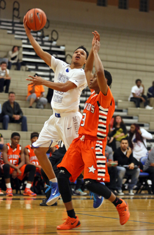 Desert Pines’ Coby Myles, left, goes for a layup past Chaparral’s Marc Silas on Wedn ...