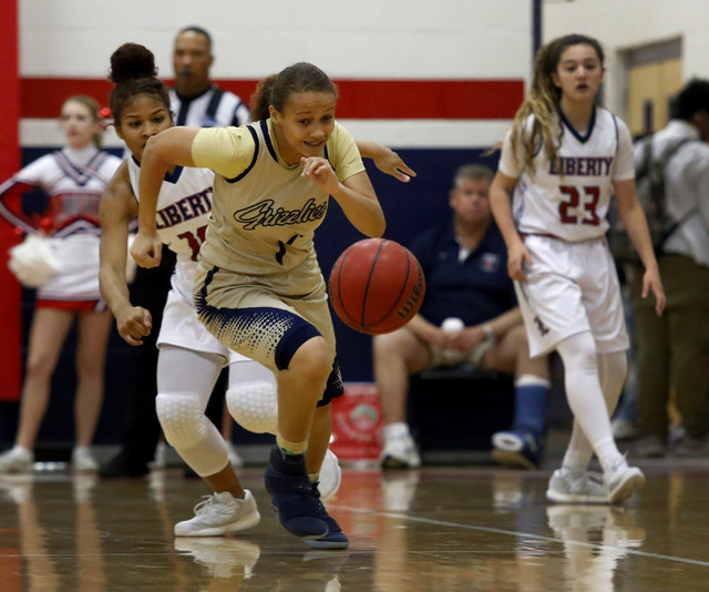 Spring Valley’s Lalique Sharpe (1) chases after a loose ball during a girls basketball ...