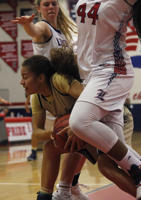 Spring Valley’s Ella Zanders (21) is fouled by Liberty’s Dre’una Edwards ( ...