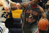 Desert Pines’ Nate Grimes (24) dunks the ball over Canyon Springs’ Dominique Jon ...