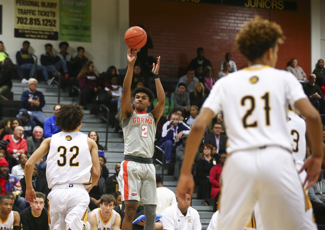 Bishop Gorman’s Jamal Bey (2) goes up for a shot against Clark during a basketball gam ...