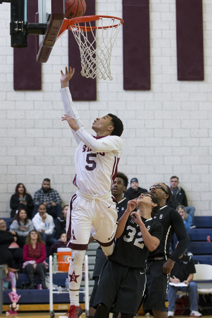 Agassi Prep’s Allen Merritt (5) goes up for a layup against Mountain View in the boy&# ...