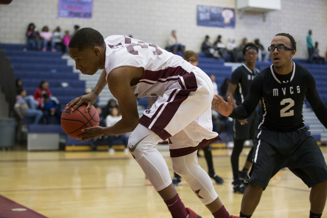 Agassi Prep’s Zhaccai Smith (35) attempts to save the ball from going out of bounds in ...