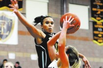 Clark’s Bobbi Floyd lines up to block a shot by Faith Lutheran’s Dani Tharaldson ...