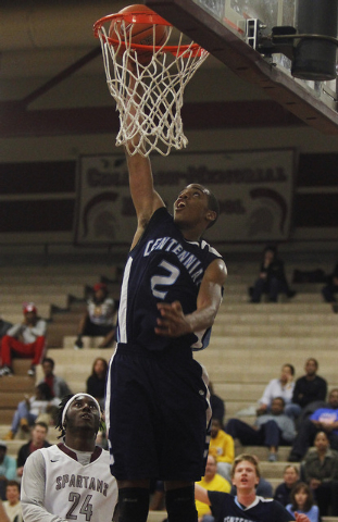 Centennial’s Troy Brown (2) goes in for a dunk past Cimarron-Memorial’s Cameron ...