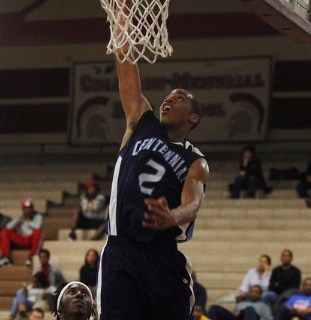 Centennial’s Troy Brown (2) goes in for a dunk past Cimarron-Memorial’s Cameron ...