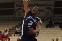 Centennial’s Troy Brown (2) goes in for a dunk past Cimarron-Memorial’s Cameron ...