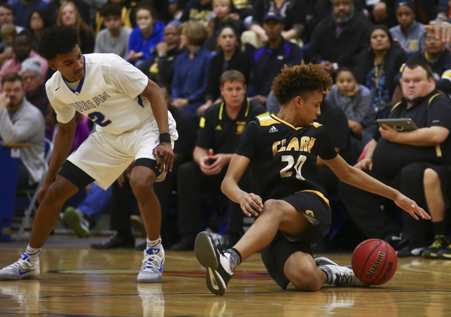 Clark forward Jalen Hill (20) trips up over the ball as Bishop Gorman Jamal Bey (2) looks on ...