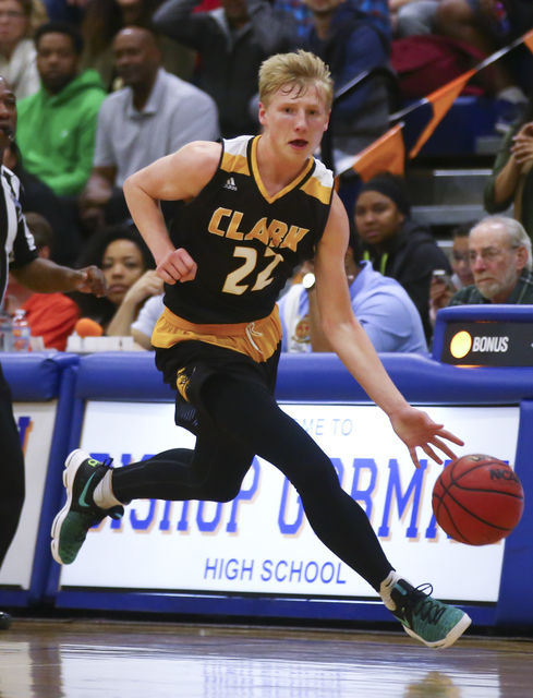 Clark guard Trey Woodbury (22) drives to the basket during a basketball game at Bishop Gorma ...