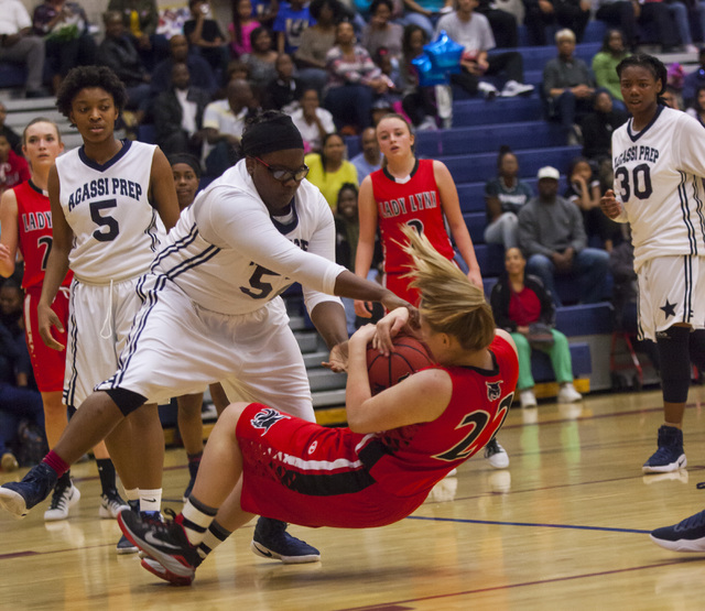 Lincoln County forward Emily Rowe (22) is tripped up by an Agassi player at Andre Agassi Col ...