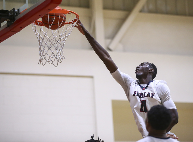 Findlay Prep forward Lamine Diane (11) scores against Planet Athlete during a basketball gam ...