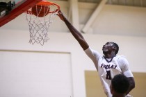 Findlay Prep forward Lamine Diane (11) scores against Planet Athlete during a basketball gam ...