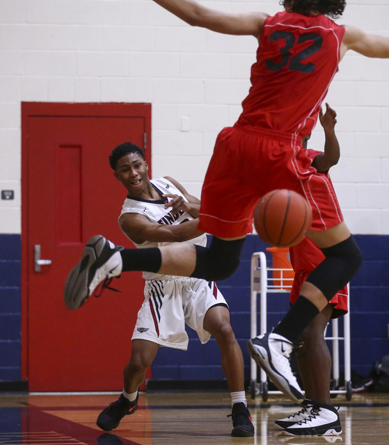 Findlay Prep guard Justin Roberts (0) makes a pass as Planet Athlete’s Trevor Irish (3 ...