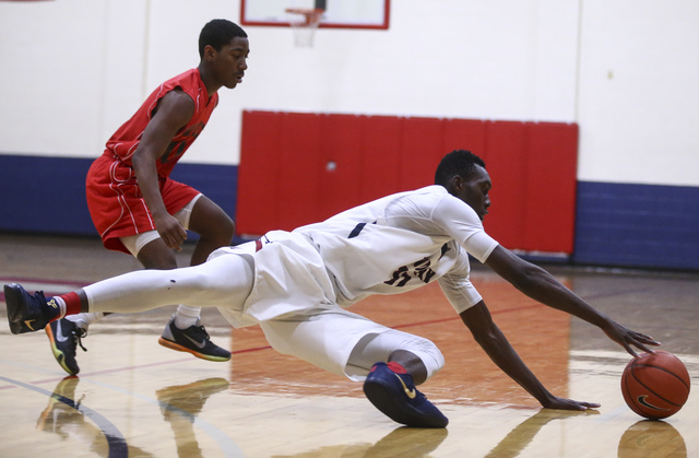 Findlay Prep forward Lamine Diane (11) dives for the ball during a basketball game against P ...