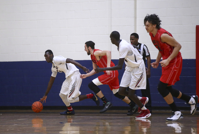 Findlay Prep forward Lamine Diane (11) drives the ball during a basketball game against Plan ...