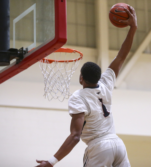 Findlay Prep forward P.J. Washington (1) goes in to dunk against Planet Athlete during a bas ...