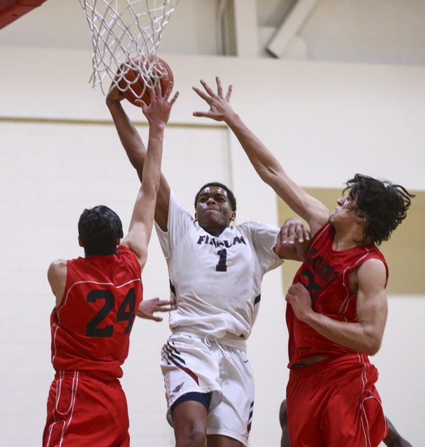 Findlay Prep forward P.J. Washington (1) shoots between Planet Athlete’s Yanis Takerbo ...