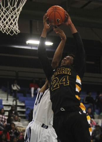 Clark’s Diontae Jones (24) grabs a rebound over Canyon Springs’ Maurice Hunter ( ...