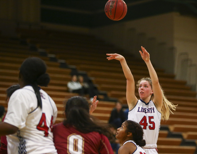 Liberty’s Amanda Pemberton (45) goes up for a shot against Downey during the Gator Win ...
