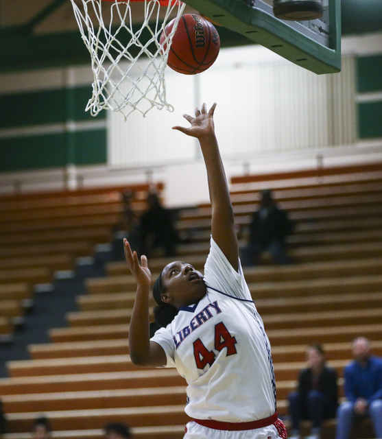 Liberty’s Dre’una Edwards (44) goes up to score against Downey during the Gator ...