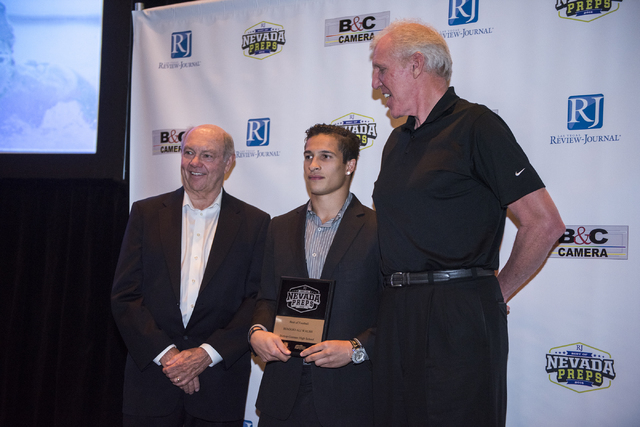 Top football and male athlete award winner Biaggio Ali Walsh, center, is seen taking a photo ...