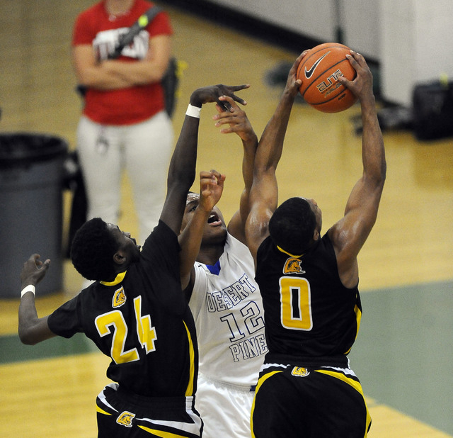 Clark guard Colby Jackson grabs a rebound as Desert Pines forward Jalen Graves (12) and Clar ...