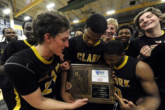 Clark Chargers players celebrate their 56-51 victory over Desert Pines in the Division I-A S ...