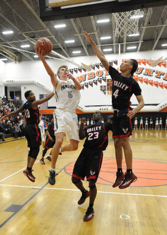 Palo Verde forward Grant Dressler (5) scores on a layup as Valley forward Taveon Jackson (4) ...