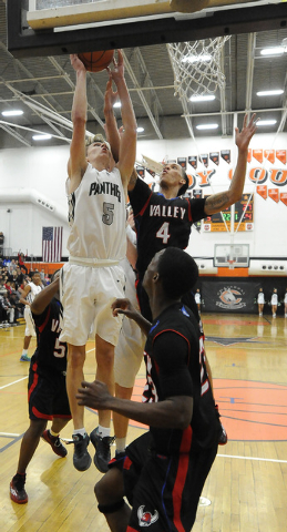 Palo Verde guard forward Grant Dressler (5) scores as Valley forward Taveon Jackson (4) defe ...