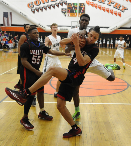 Valley forward Taveon Jackson, middle, fights Palo Verde center Jamell Garcia-Williams for a ...