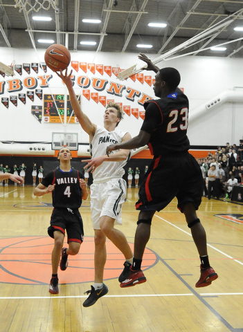 Palo Verde forward Grant Dressler, middle, goes up for a layup in front of Valley forward Ni ...