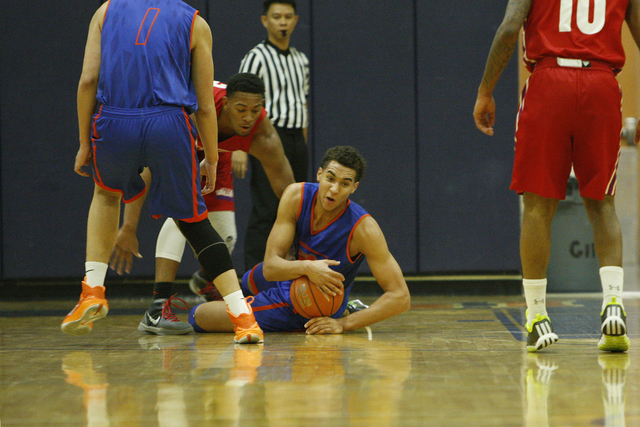Bishop Gorman’s Chase Jeter (4) goes to the floor to control the ball during their scr ...