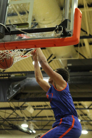 Bishop Gorman’s Chase Jeter (4) dunks the ball during a scrimmage against Valley on Tu ...