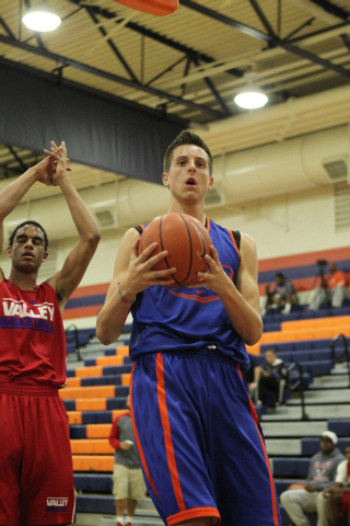 Bishop Gorman’s Zach Collins (12), right, reacts after a play during their scrimmage ...