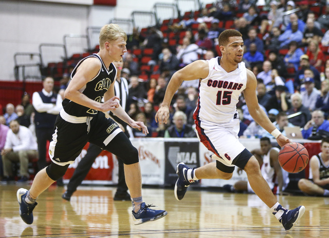 Coronado’s Bryce Savoy (15) drives to the basket past Clark guard Trey Woodbury (22) d ...