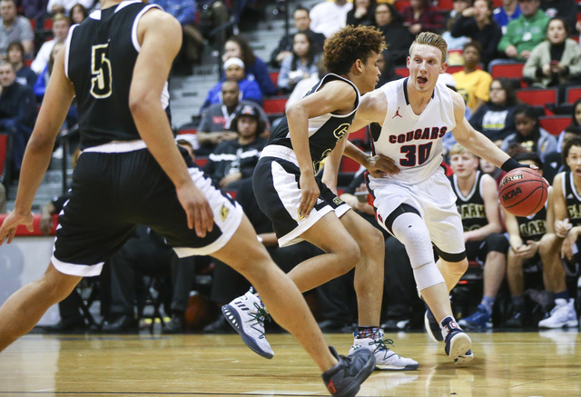 Coronado’s Kennedy Koehler (30) drives against Clark forward Jalen Hill (21) during th ...