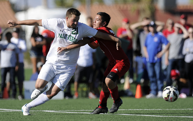 Palo Verde striker Jaden Ketelsen (21) tries to get around Valley defender Isaiah Cardenas d ...