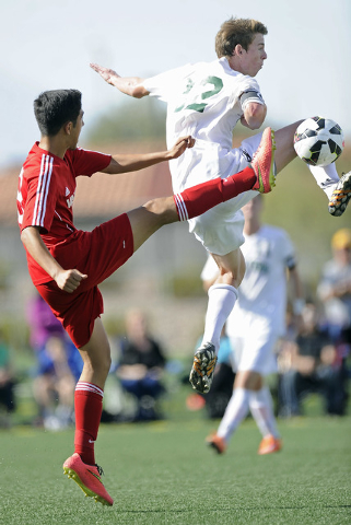 Palo Verde defender Griffin Mallas (12) challenges Valley midfielder Alejandro Parra, left, ...