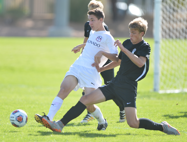 Coronado High School’s Brock Rideout (16), left, kicks the ball past Galena High Schoo ...