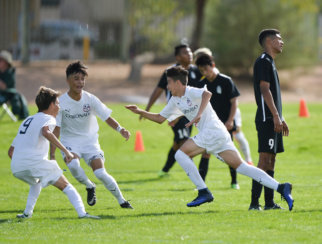 Coronado High School’s Alredo Diaz (13), center, celebrates his 1-0 goal with teammate ...