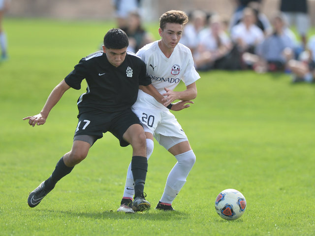 Coronado’s John Baldauf (20) and Galena’s Rodrigo Contreras (17) battle for the ...