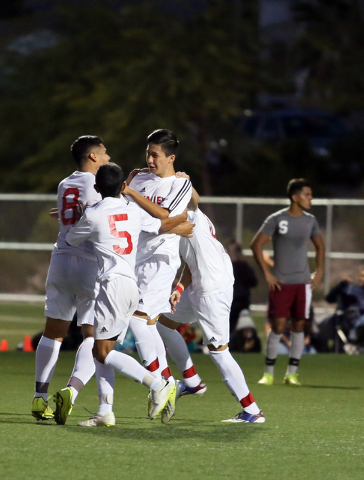 Valley’s Marco Gonzales, third from left, is swarmed by teammates after scoring a goal ...