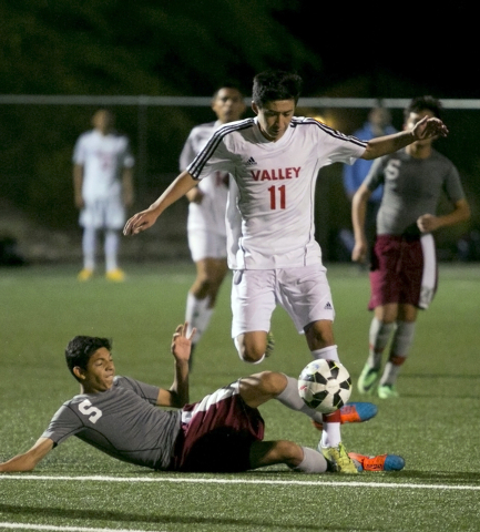 Valley’s Marco Gonzales, top, jumps over Cimarron-Memorial’s Luis Gallardo, bott ...