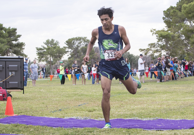 Omar Rubio, from Green Valley High School, finishes first during the Regional 4A Sunrise Boy ...