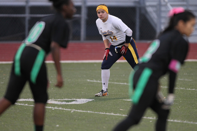 Boulder City quarterback Jeanne Carmell (14) plays defense during their flag football game a ...