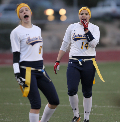 Boulder City quarterback Jeanne Carmell (14) with her teammate Oshanna Remy (8) react to a p ...