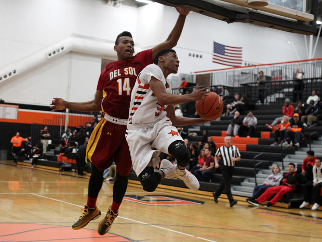 Chaparral guard Marc Silas leaps towards the basket while being defended by Del Sol forward ...