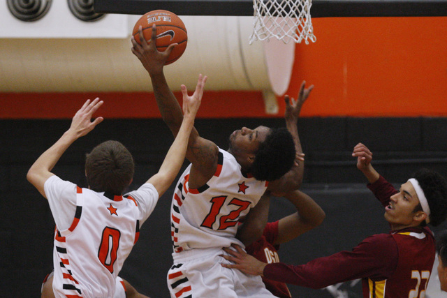 Chaparral center Maharie Trotter grabs a rebound while being defended by Del Sol forward Jon ...