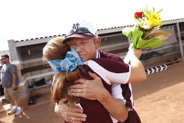 Cimarron-Memorial softball coach Steve Gorden hugs player Michelle Knott during a ceremony h ...